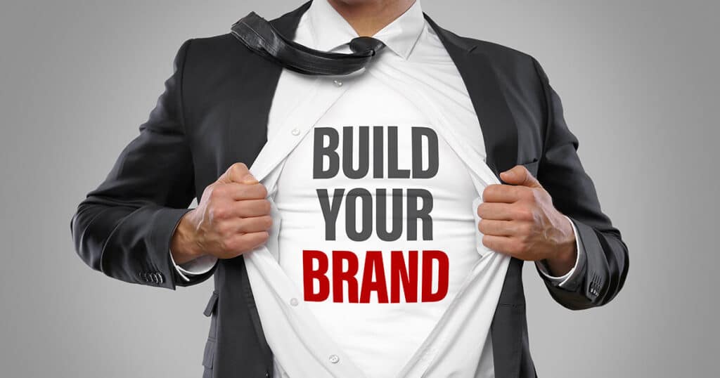 "Build Your Brand" written on businessman's t-shirt